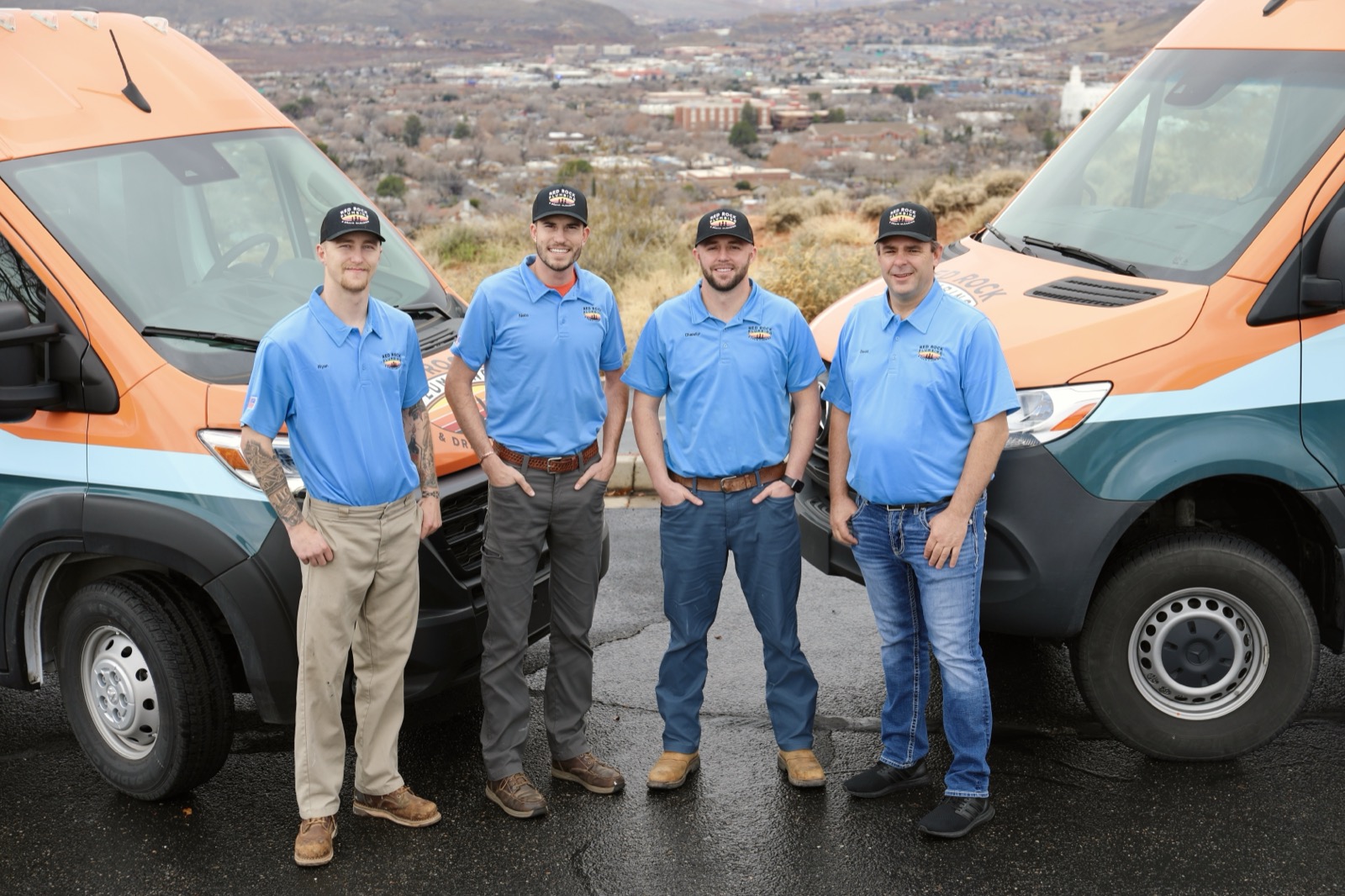 Red Rock Plumbing team standing between company vans